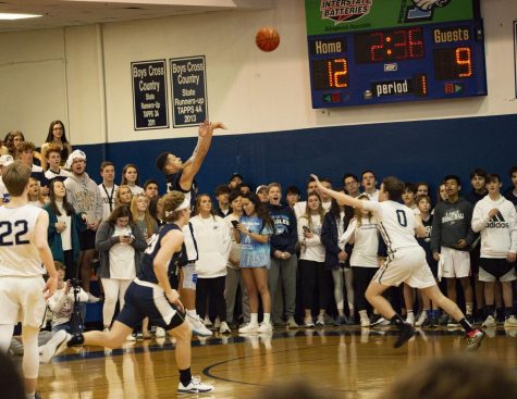 Sophomore Zeke Long shoots a three point shot early in the game. Long went on to be the leading scorer for the Mustangs.