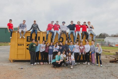 The whole Arkansas group poses for a picture after a couple hours of manual labor.