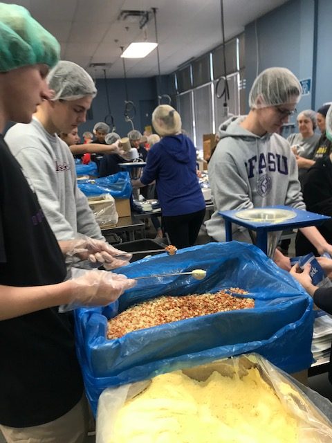 Seniors Blake Rogers, Jonathan Greenwell, and Caleb Bryant work the assembly line at Feed My Starving Children.
