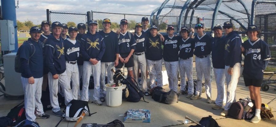 After a long fought game, the baseball team poses for a picture after an away game.