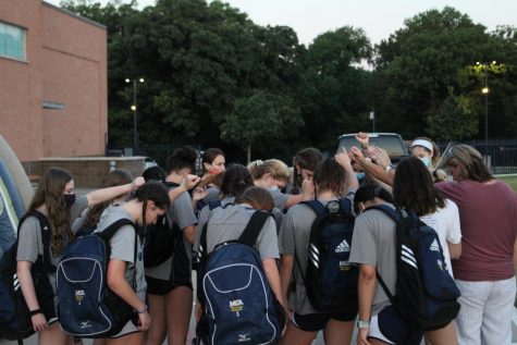 The Volleyball team praying after receiving uniforms and enjoying breakfast with one another.