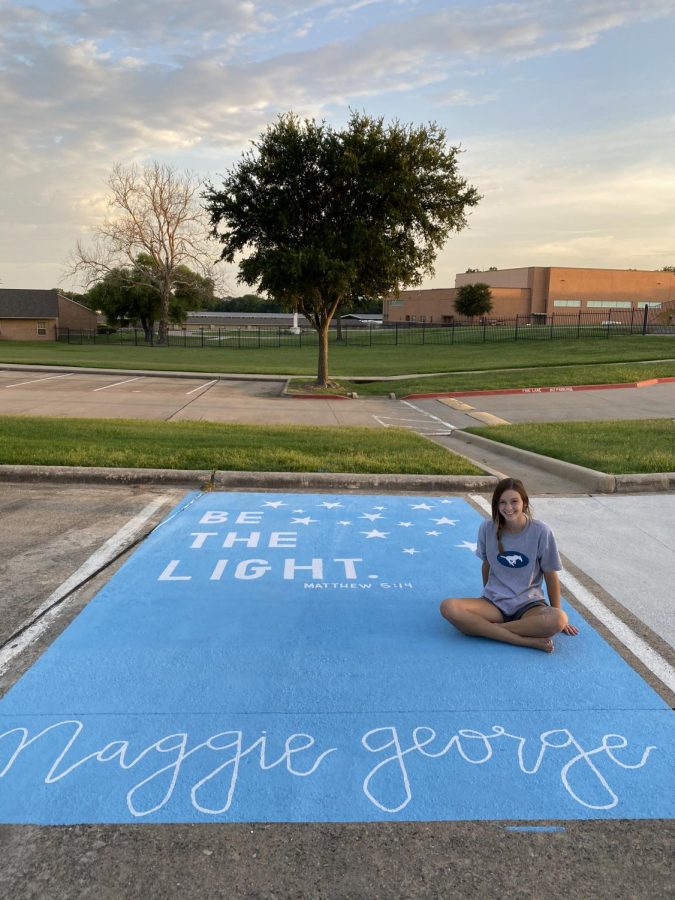 Senior Maggie George poses with her parking spot