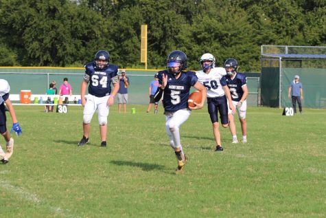 Eighth grader Jeremiah Daoud runs the ball to get the first down.