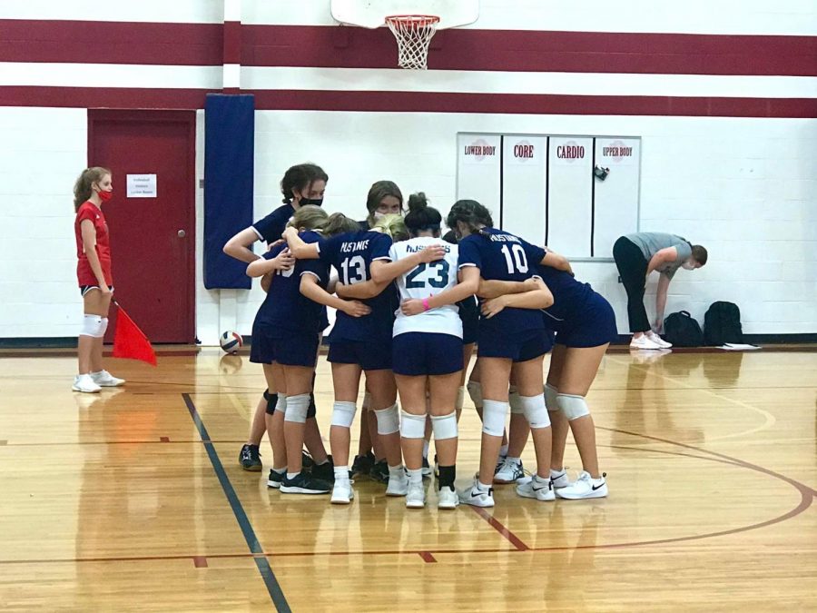 D1 girls team huddling during their game against Grapevine Faith.