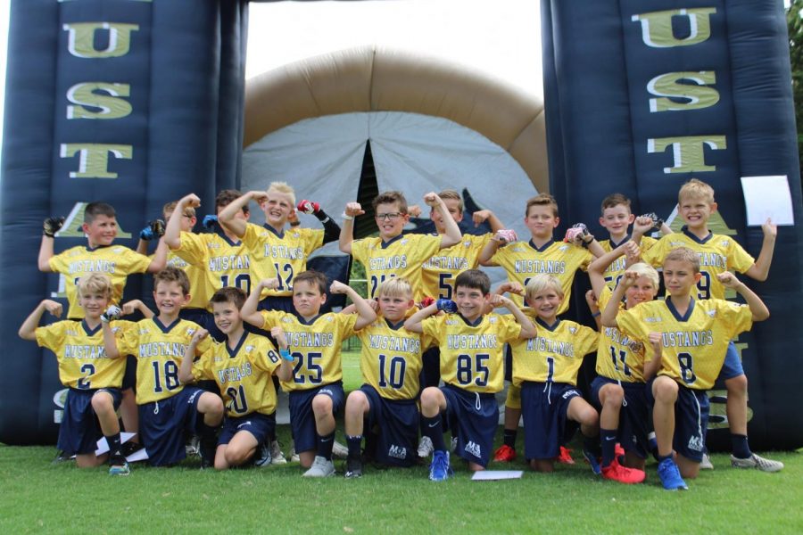 The Fourth Grade Blue and Gold Teams show off their muscles and their new uniforms.