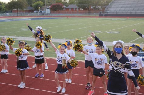 Lil Stangs cheer performs during the second quarter at the homecoming football game. 