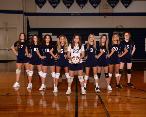 All eighth grade volleyball players pose for a picture.