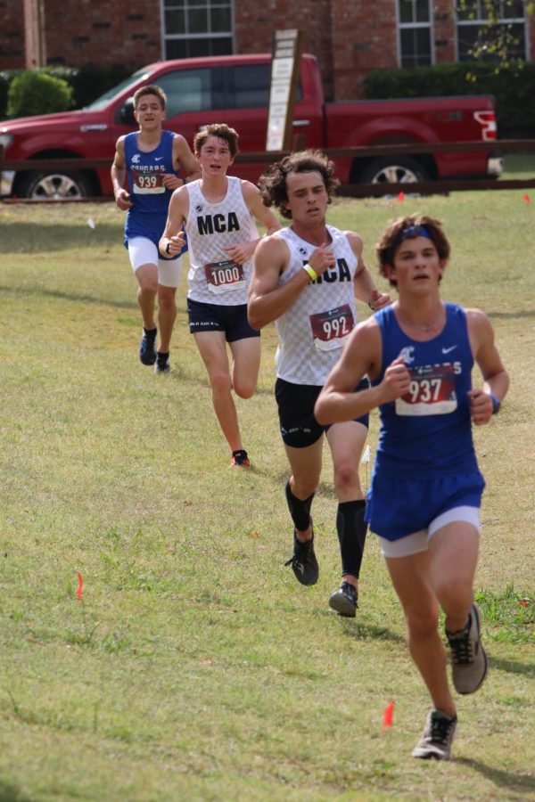 Varsity runners, senior Peter Michael Clark and freshman David Roller, fight for second and third place.