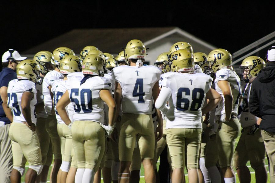 Mustangs+huddle+during+a+timeout+to+go+over+plays.