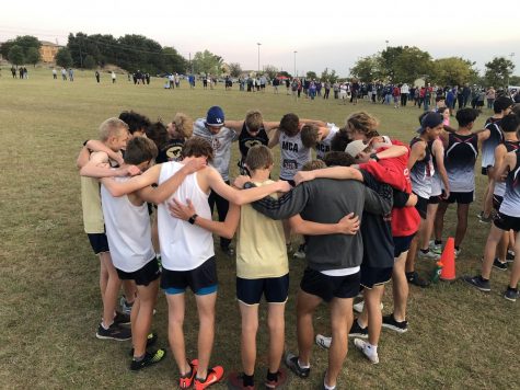 The Mustangs pray before the race. 
