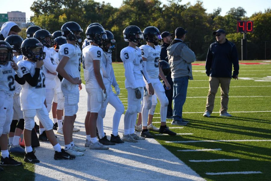 The Mustangs gather on the sideline after calling a timeout. 