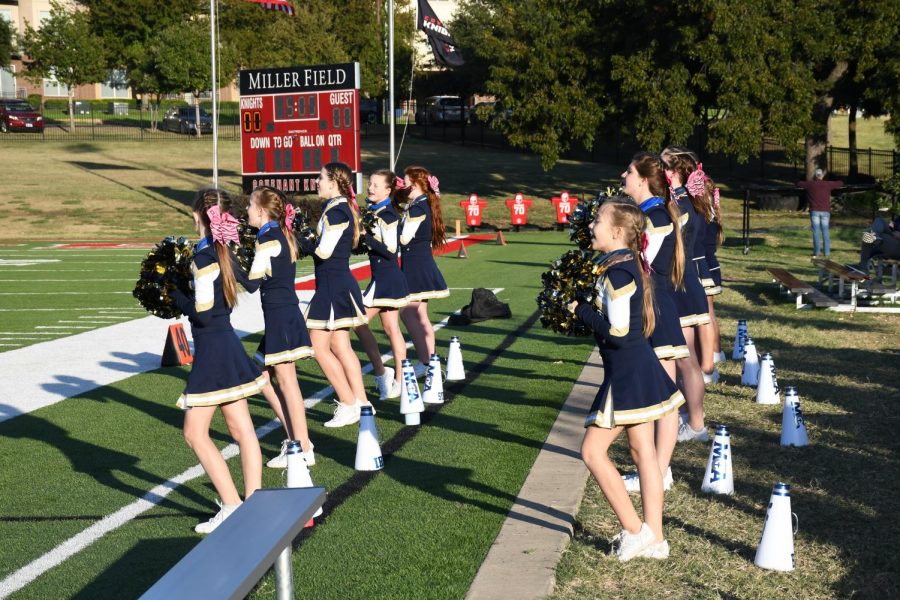 The Middle School Cheerleading team cheers on the Mustangs.