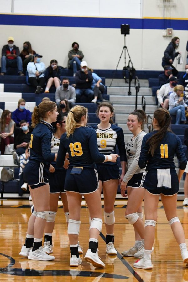 The+Lady+Mustangs+huddle+together+before+the+game+starts.