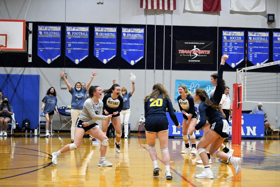 The Mustangs celebrate after winning a crucial point.