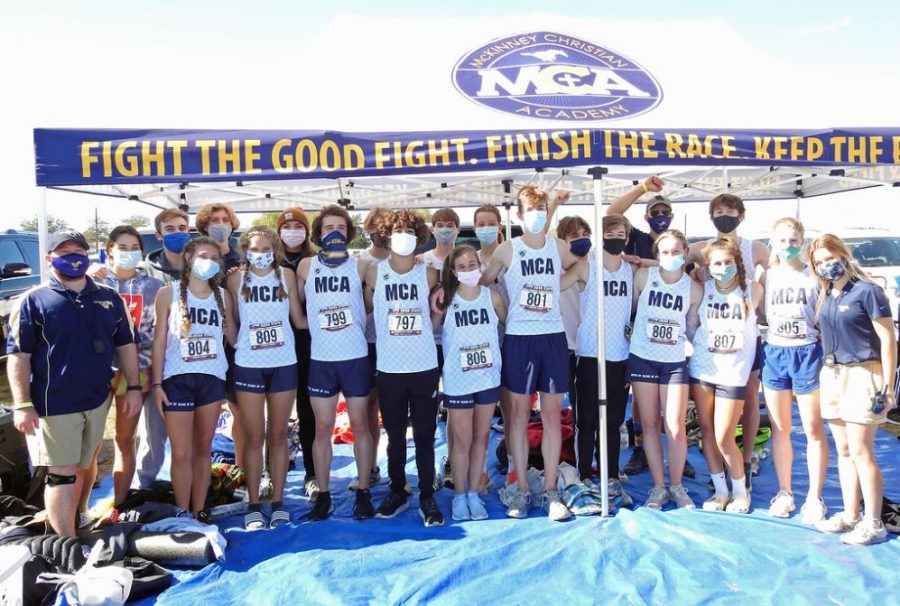 The varsity cross country teams pose for a photo after running.