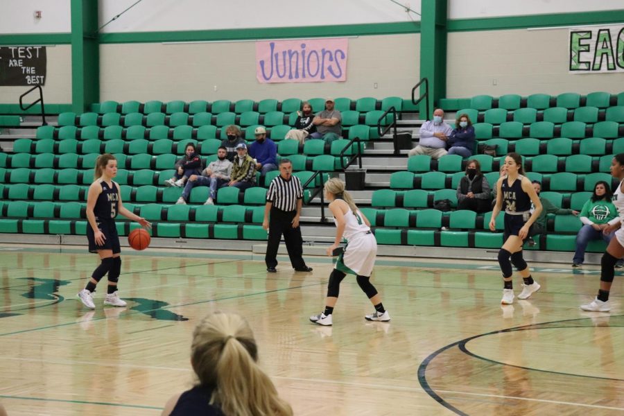 Junior Maddie Clark dribbles the ball up the court for the Lady Mustangs. 