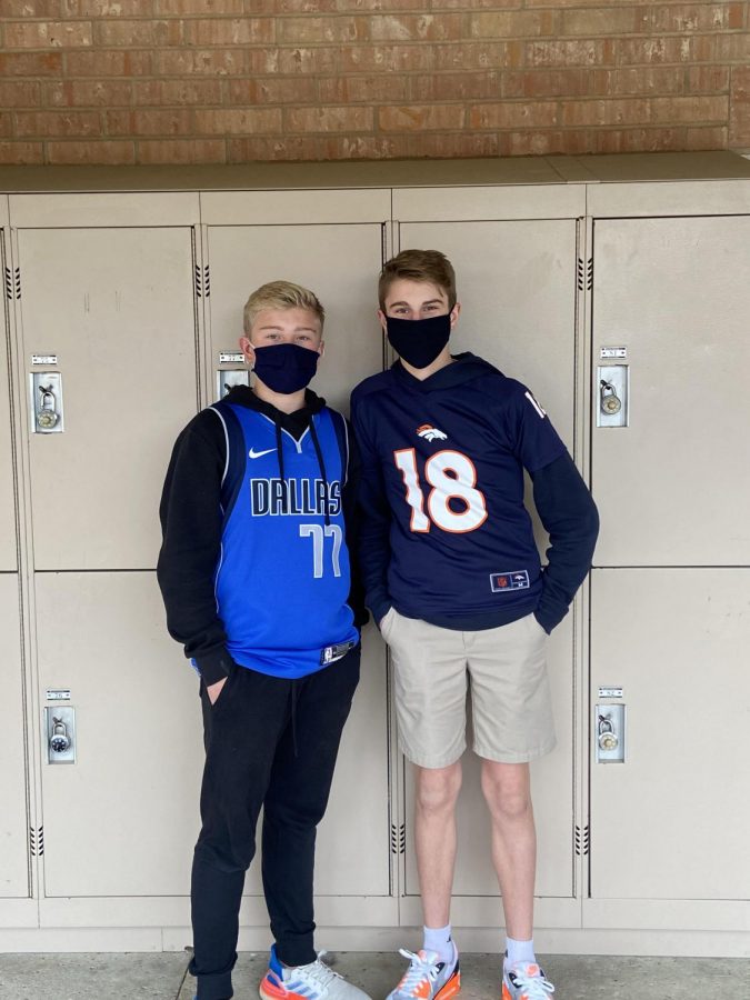 Eighth graders Caleb Atherton and Jude Westra take a photo in their athlete attire.