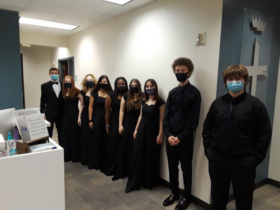 The choir members line up for a picture after their performance.