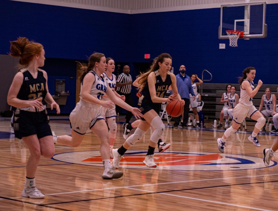 Sophomore Abby Thomas dribbles the ball past the defender and goes in for the layup.