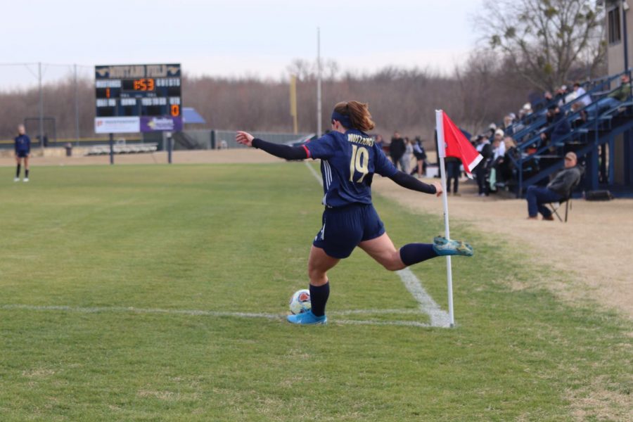 Senior+Annie+Weichel+taking+a+corner+kick+for+the+mustangs.+