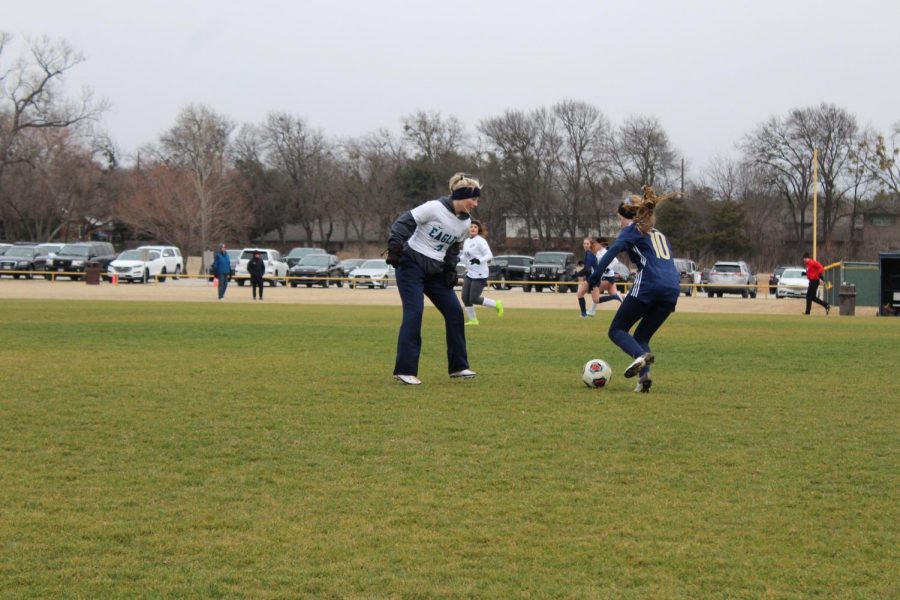 Sophomore Leigh Evan Kitzmiller carrying the ball pass the defender for the mustangs. 