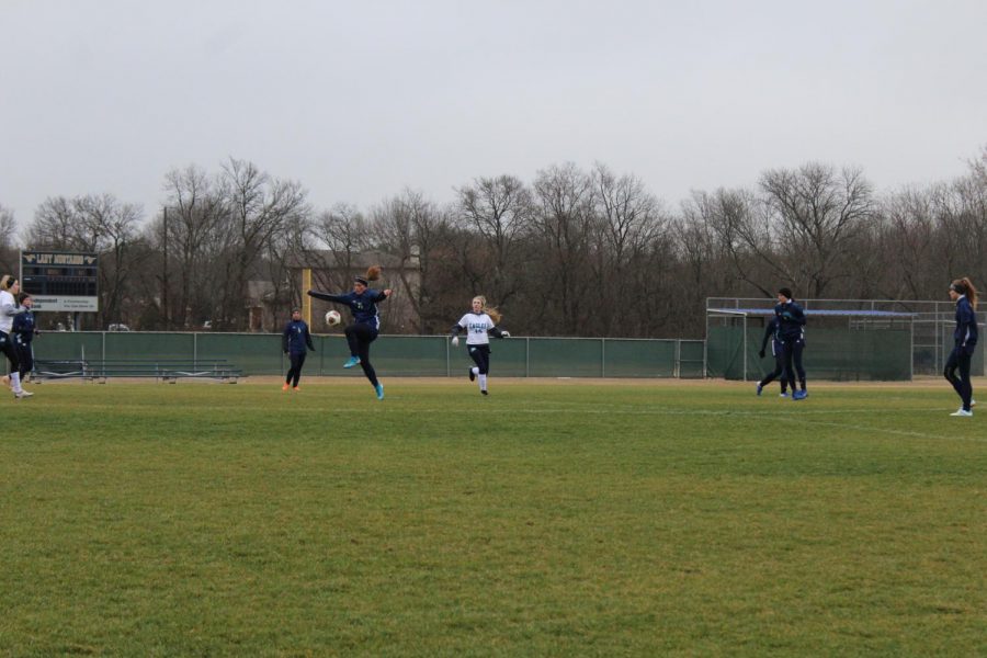 Senior Annie Weichel kicks the ball down the field to a teammate.