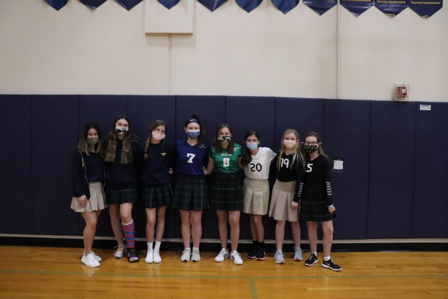 Some of the lower and middle school club volleyball players pose for a picture. 