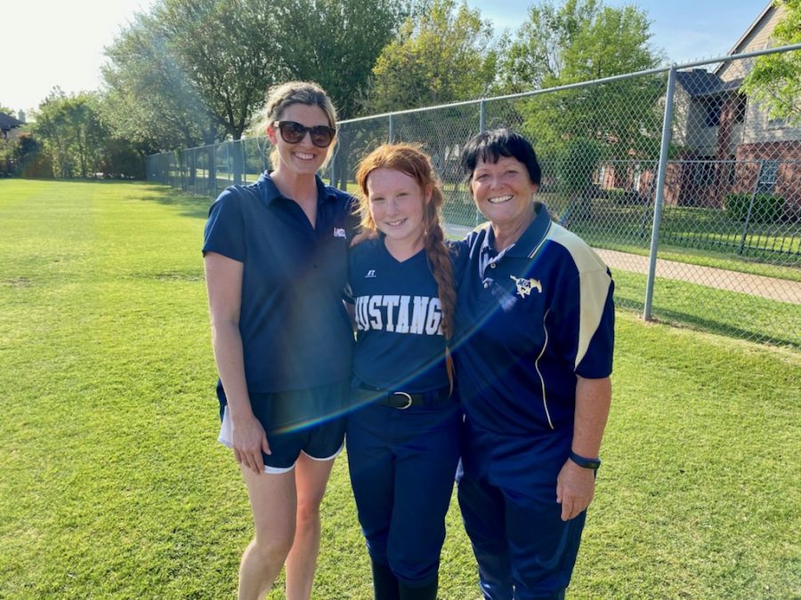 6th grader Madison White stands with her coaches after the game for a picture.