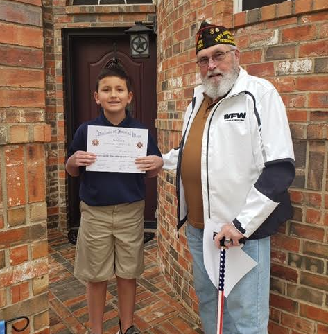 Sixth grader Jonathon Rincones-Peters receives his Patriot's Pen certificate. 