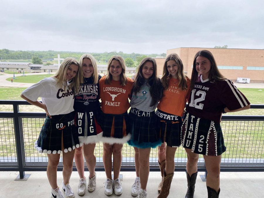A+group+of+senior+girls+take+a+picture+wearing+their+college+skirts.