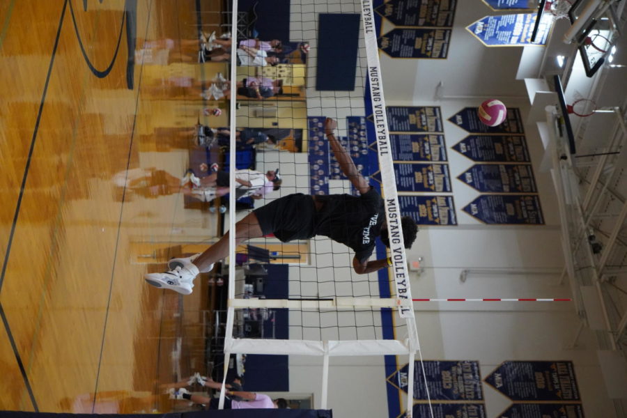 Senior Jaylen Johnson jumps for a kill in boys volleyball. 