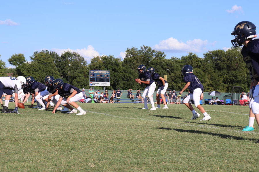 The middle school offense lines up to snap the ball.