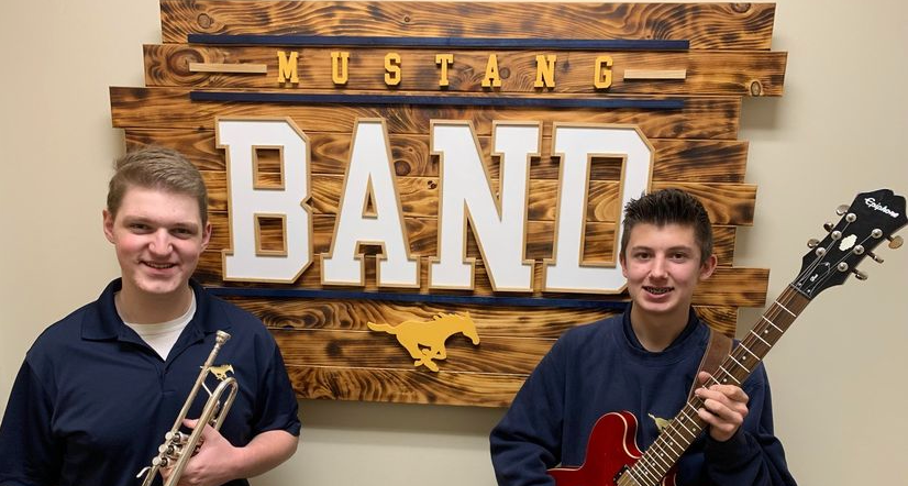 Sophomores Aiden Ewing and Jackson Iseneker pose for a picture with their jazz instruments.  