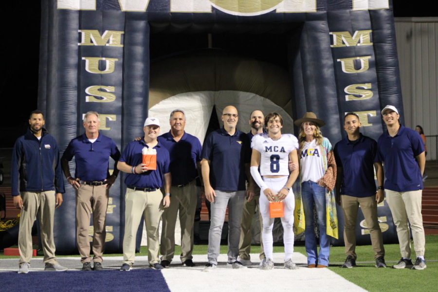 Sutton Mayberry poses with his family and coaches during the senior night presentation. 