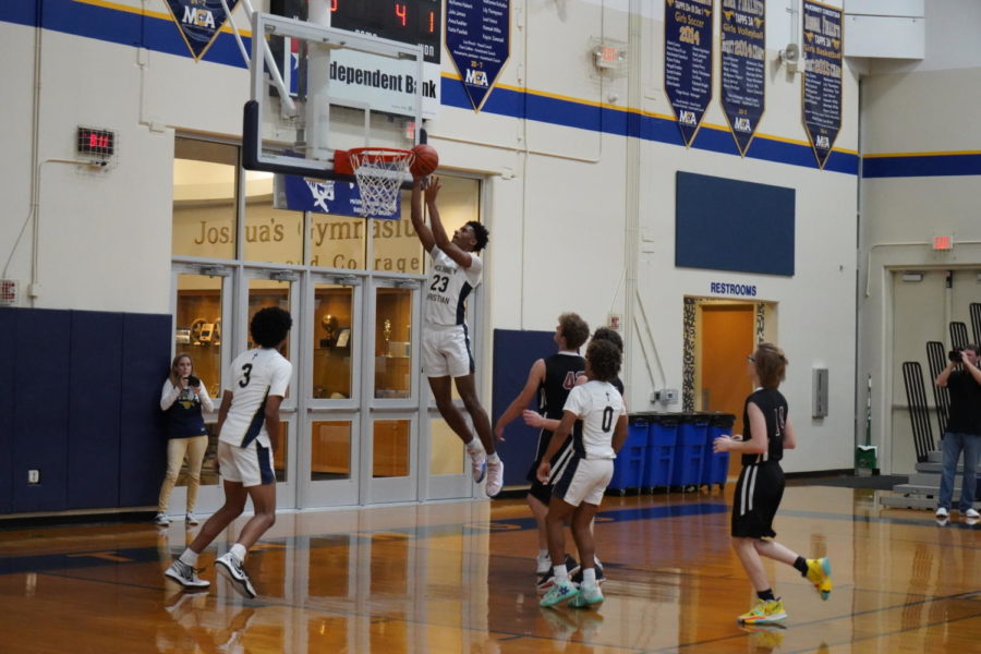 Senior Joshua Thrower goes for a dunk.