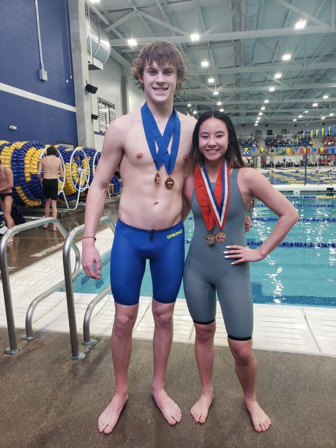 Freshman Carter Kincheloe and Junior Tiffany Nordstrom are rewarded with medals after the meet. 