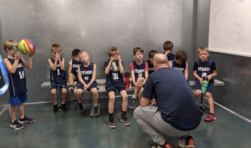 Lil Stangs pray for their upcoming game.