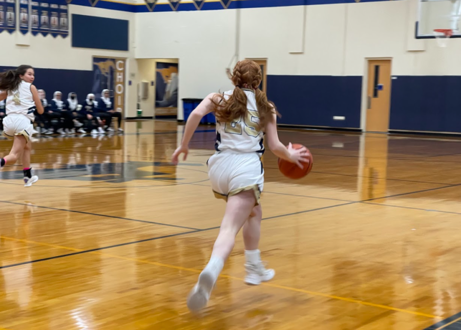 Sophomore Grace Krause dribbles down the court.