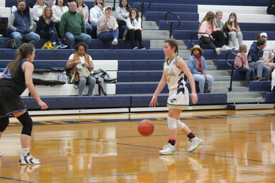 Senior Maddie Clark takes the ball up the court. 