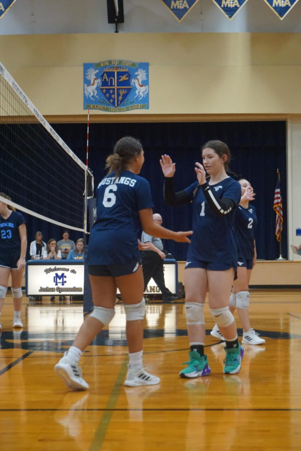 Isabella Melton, seventh, and Bailey Gerardis, eighth, work together to score a point.