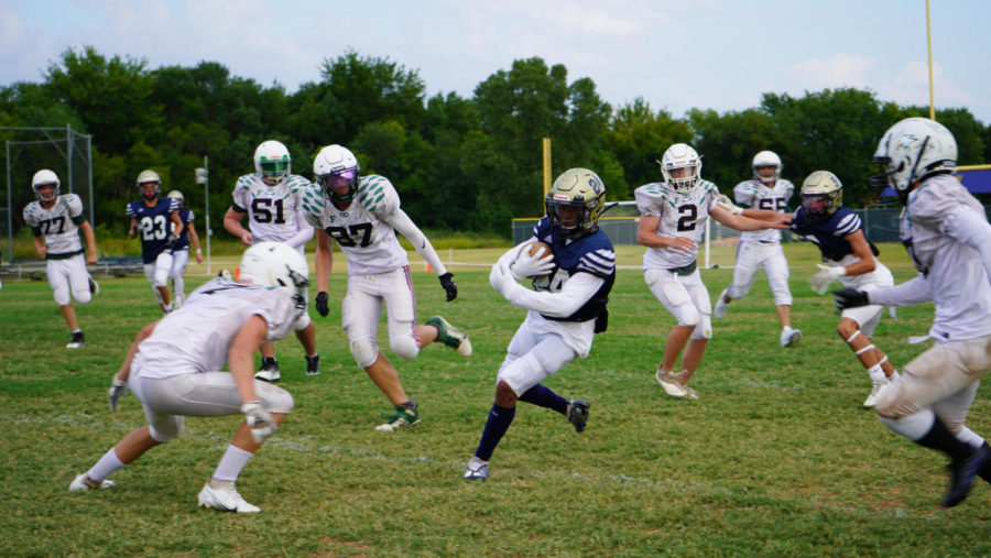 Junior Noah Wheeler runs past defenders after a catch