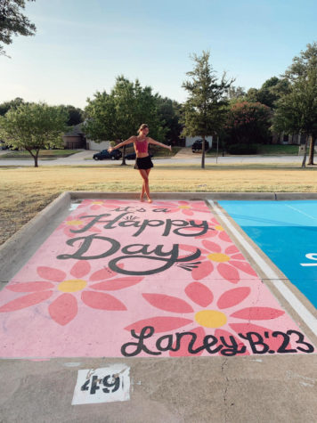 Senior Laney LeBlanc paints Its a Happy Day on her parking spot. 