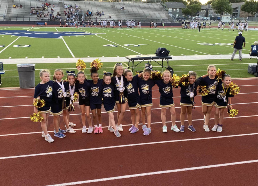 Lil Stangs Cheerleaders smile for a picture at the Homecoming game. 