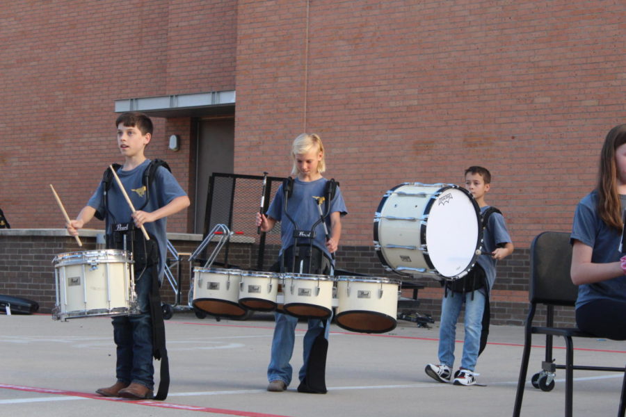 Sixth grade drumline prepares for their next song.