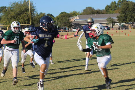 Eighth grader Harrison Thompson runs the ball.