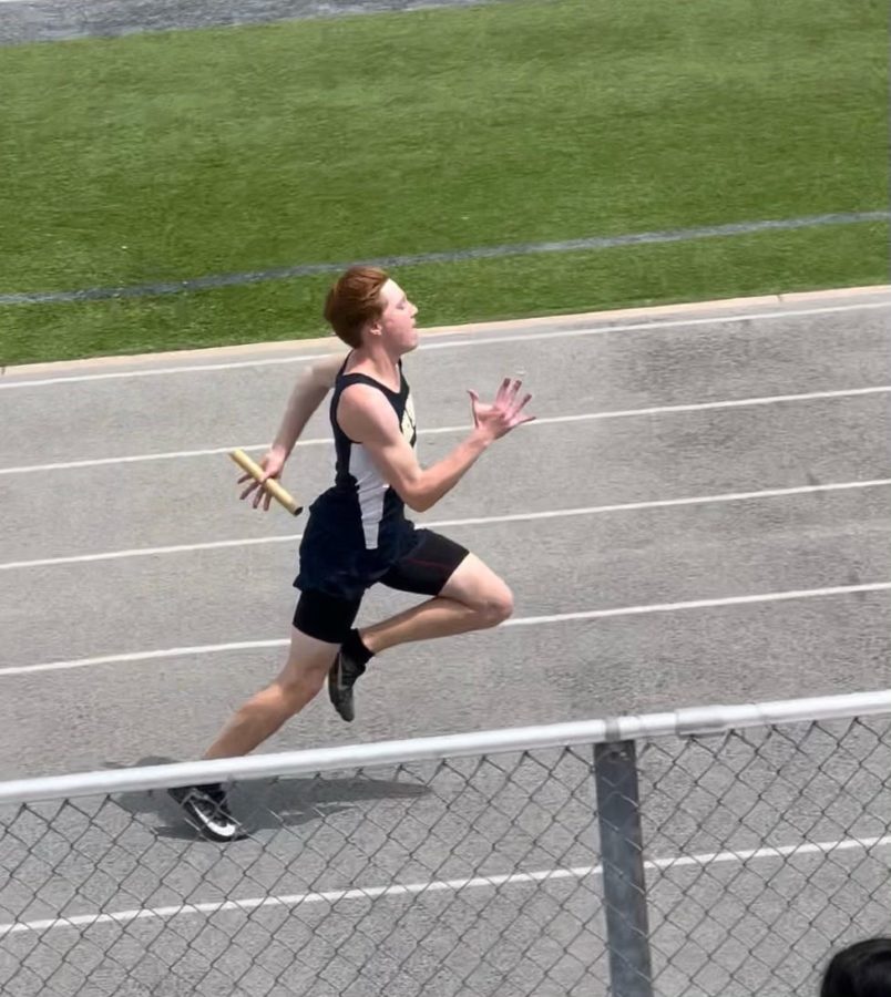 Junior Jacob Dover-Smith competes in 4x100