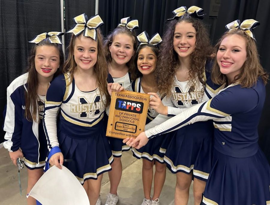 Varsity cheer team shows off State Runner-up title. 