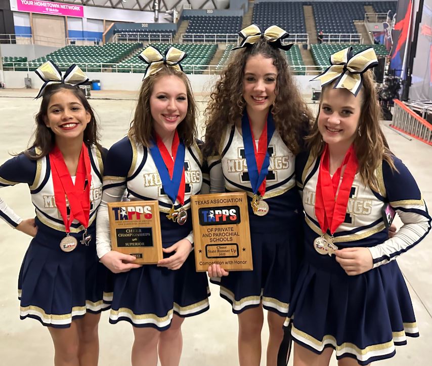 Varsity cheer team members Elise, Ava, Destiny, and Libby pose for a photo after receiving their titles. 