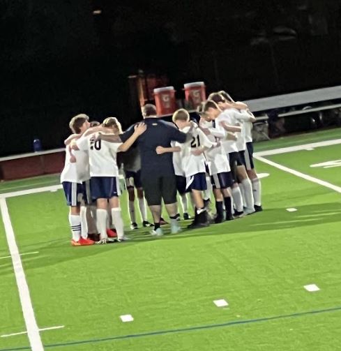 Middle School boys soccer finishes with a team prayer. 