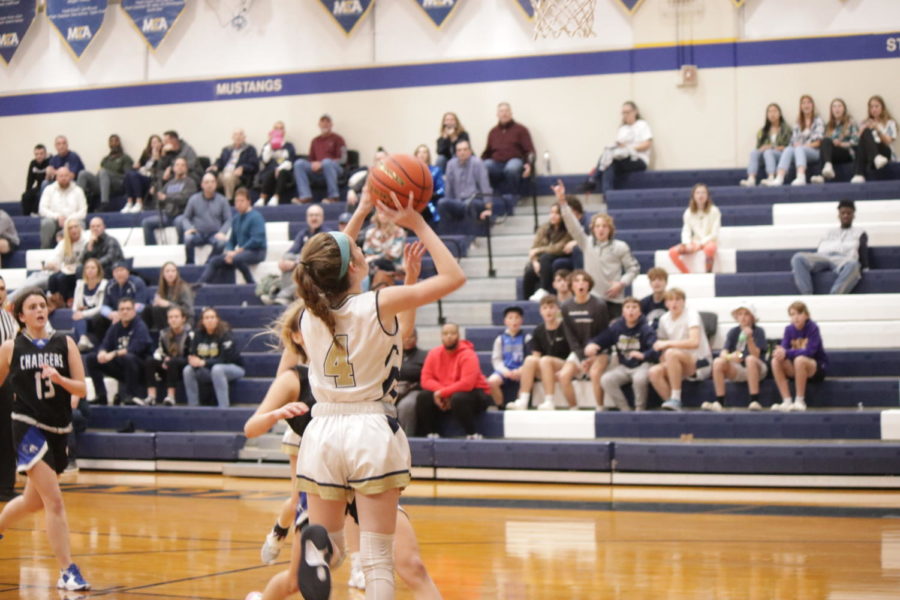 Lady Mustangs player makes a shot